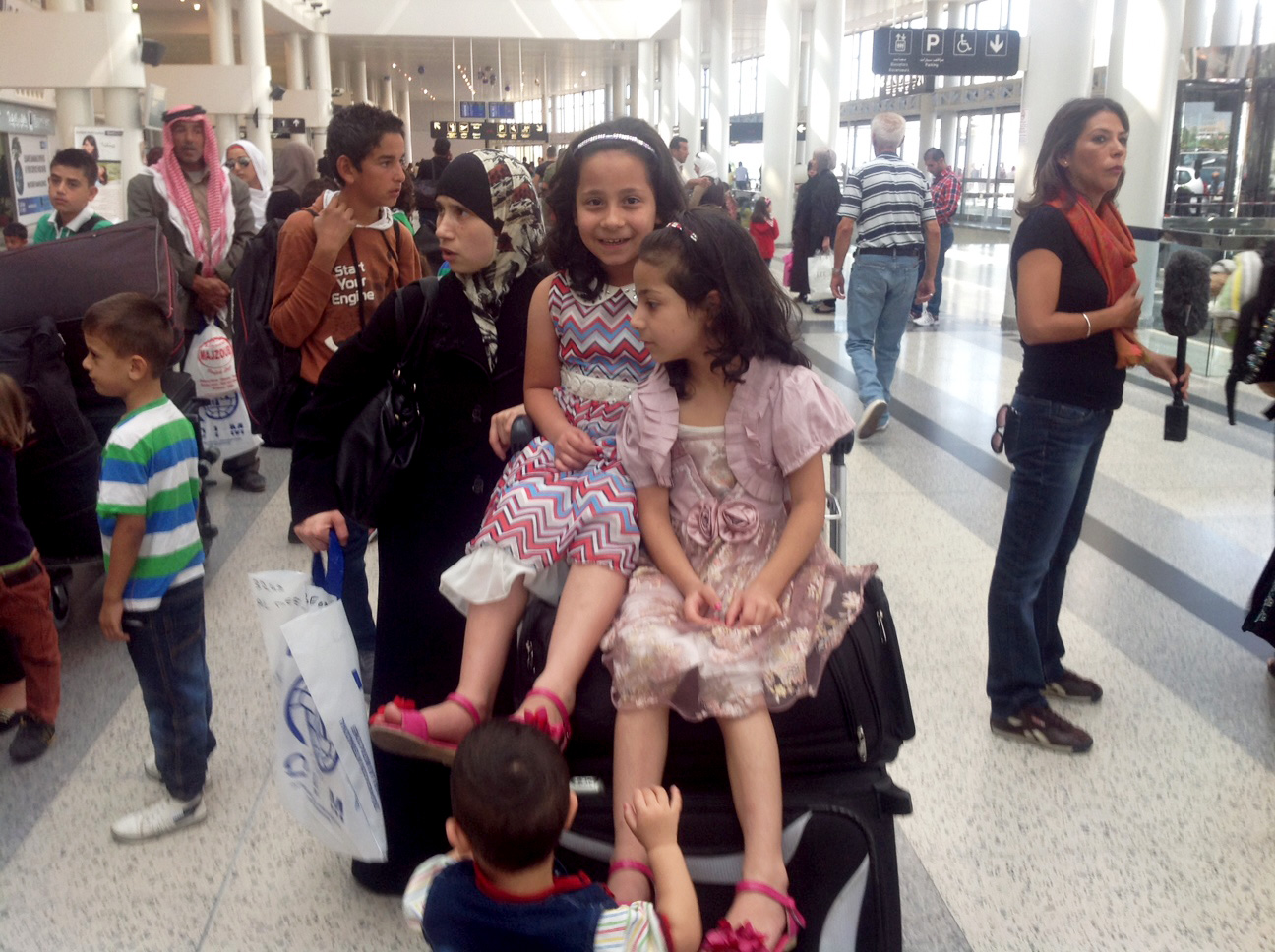 President Clinton greets Syrian refugees with cupcakes, compassion and puppies